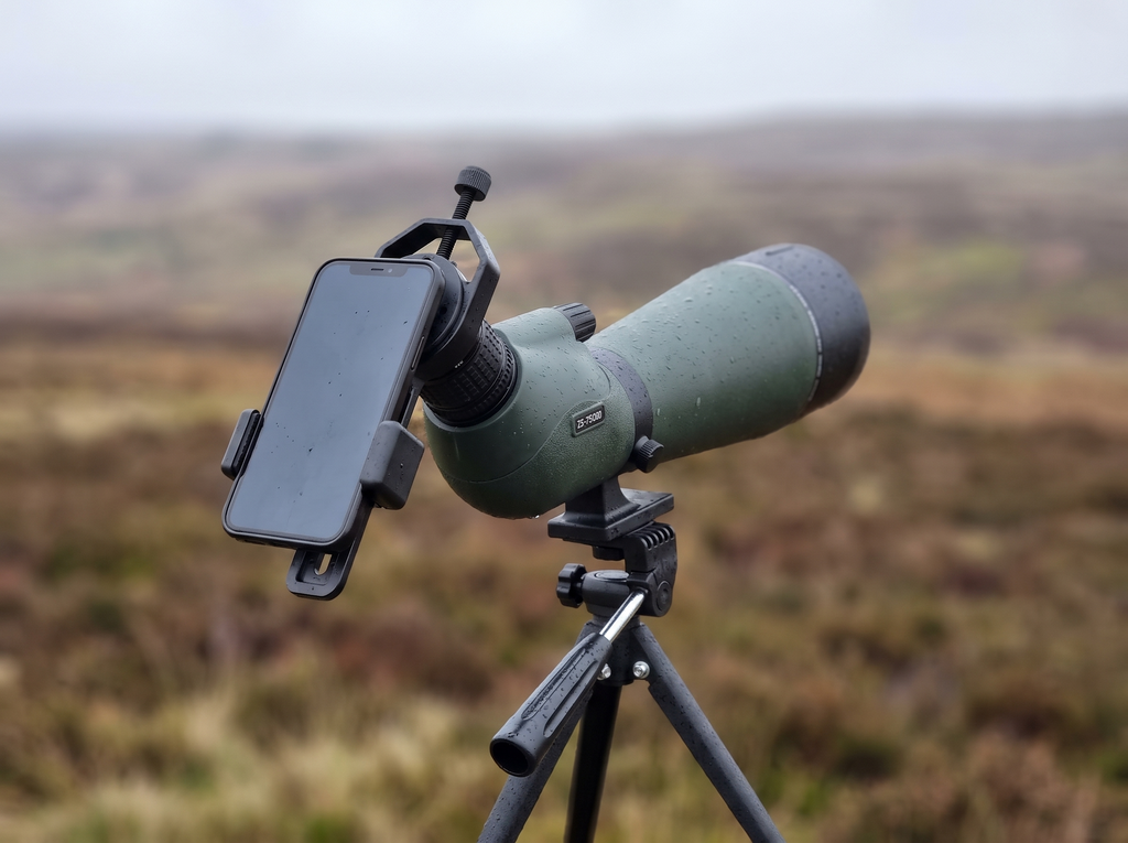 Smartphone mounted on the eyepiece with the phone adapter