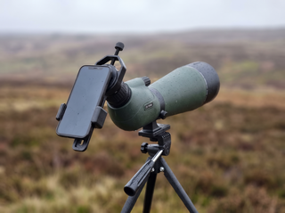 Smartphone mounted on the eyepiece with the phone adapter